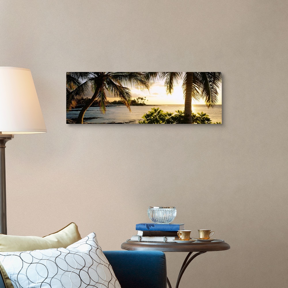 A traditional room featuring Panoramic wall art photo for the office or home of the Hawaiian coast; palm trees frame the sun s...