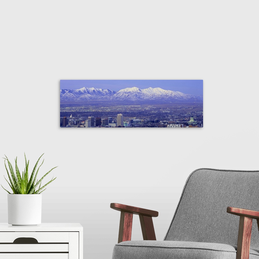 A modern room featuring Panoramic sunset of Salt Lake City with snow capped Wasatch Mountains