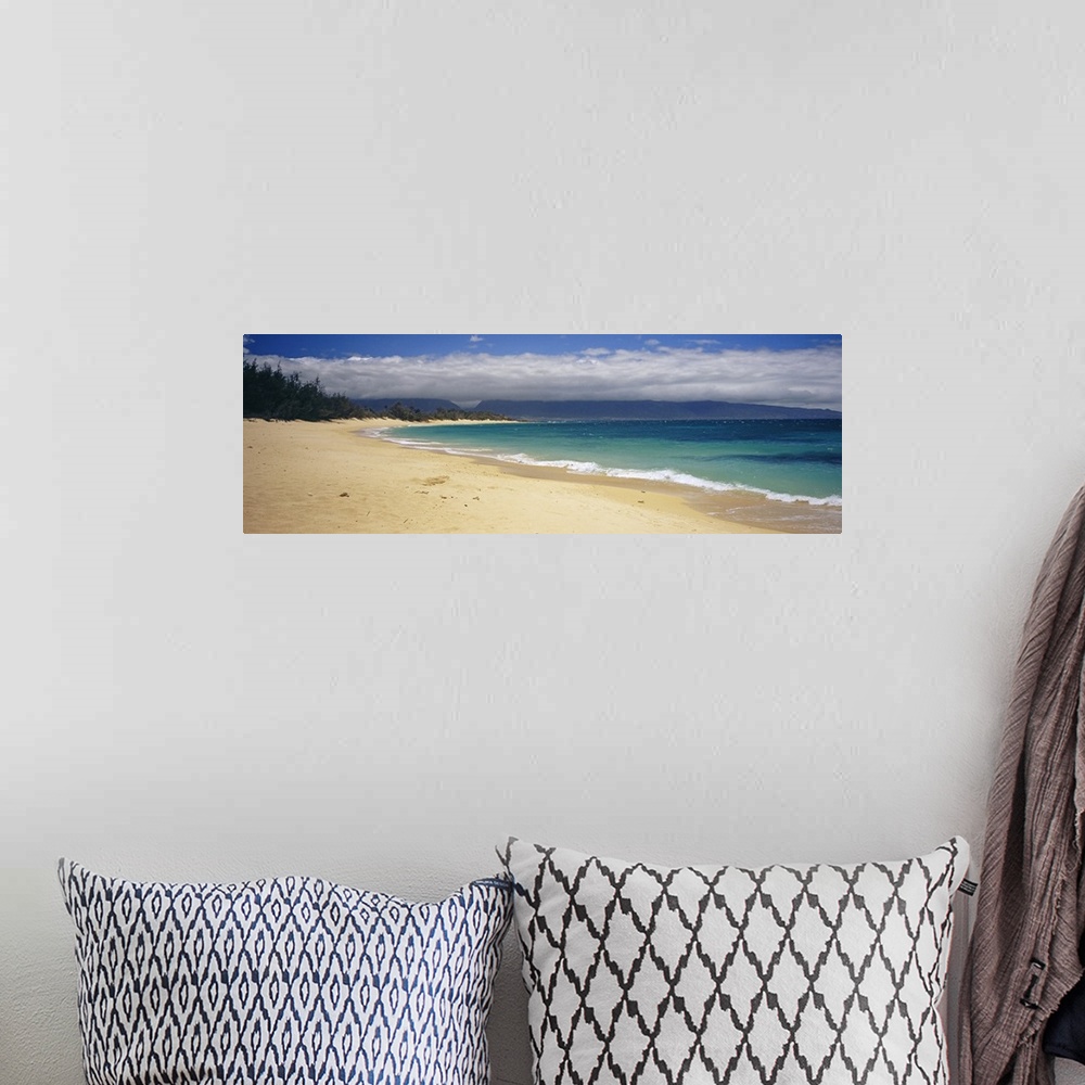 A bohemian room featuring Wide angle photograph on a large wall hanging of clear blue waters along the beach in Maui, Hawai...