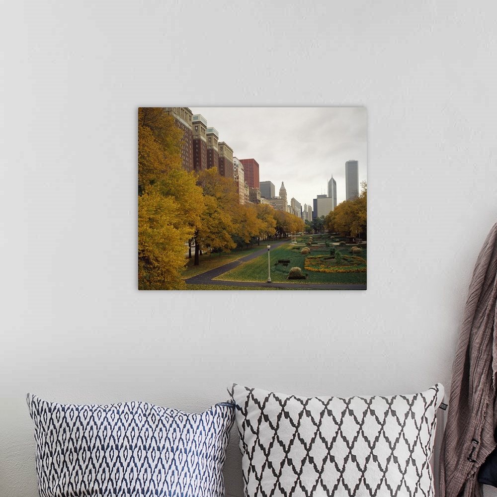 A bohemian room featuring A Chicago park in autumn is photographed with buildings just to the left and behind it in the dis...