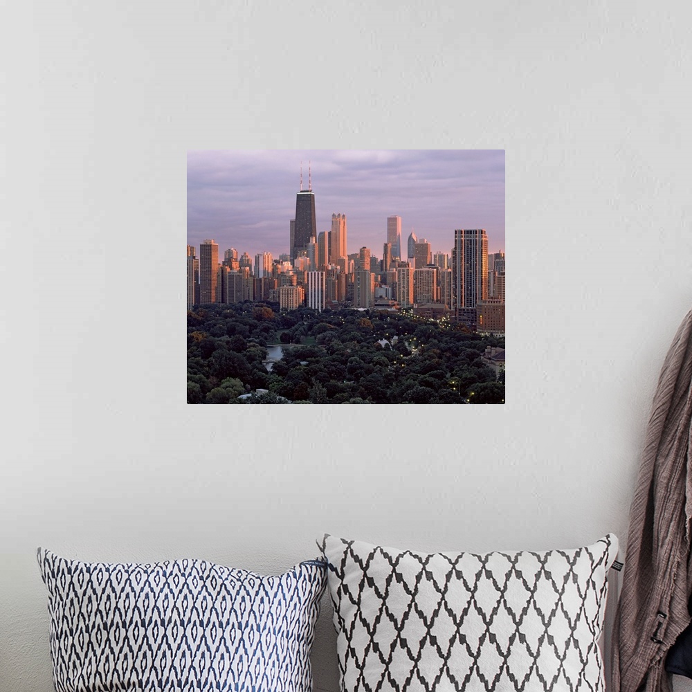 A bohemian room featuring This twilight photograph of the downtown shows the interior of a city park and many major city sk...