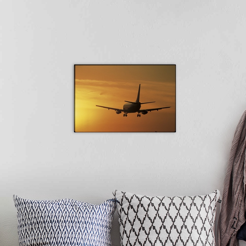 A bohemian room featuring Photo print of a jumbo jet flying into a sunset after take off.