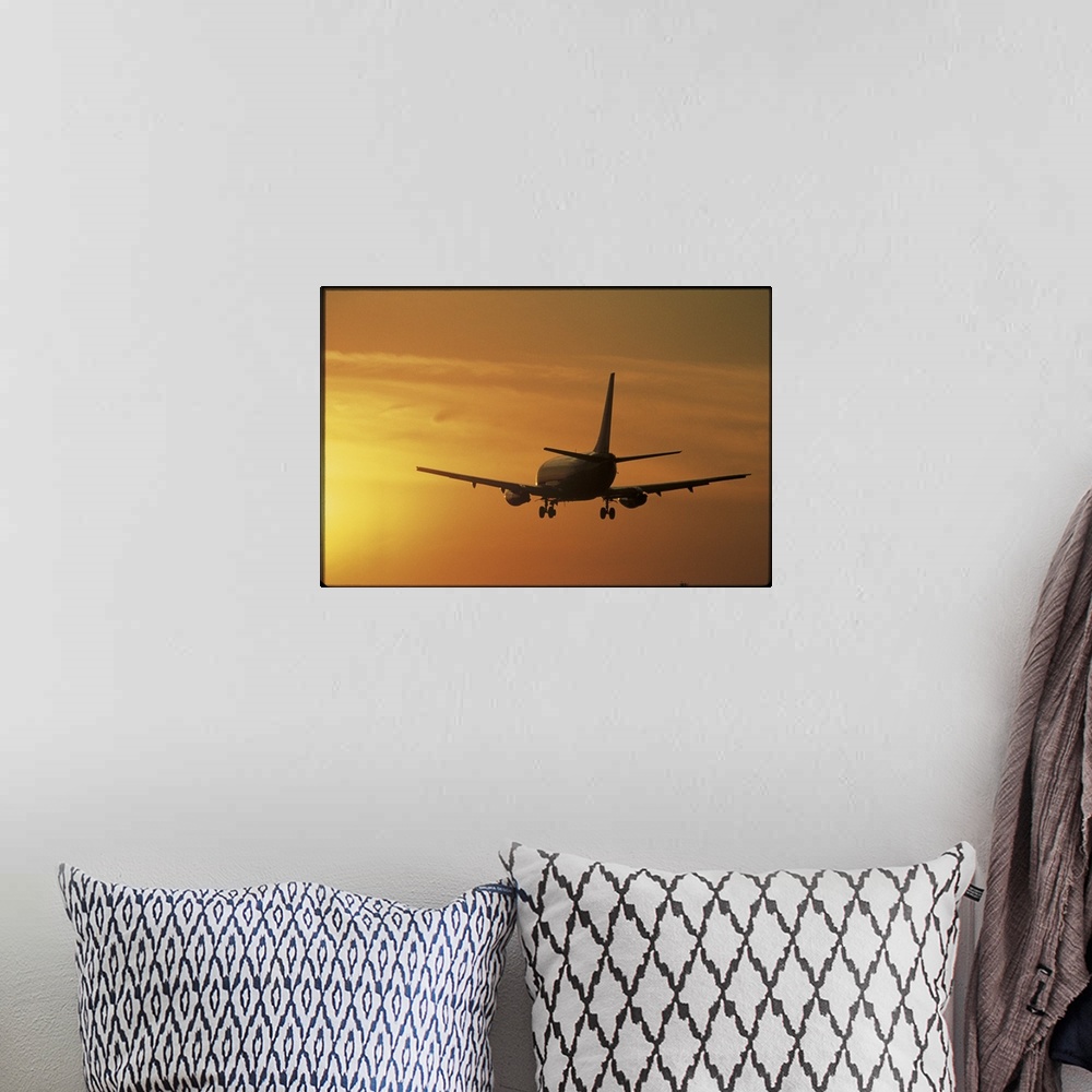 A bohemian room featuring Photo print of a jumbo jet flying into a sunset after take off.