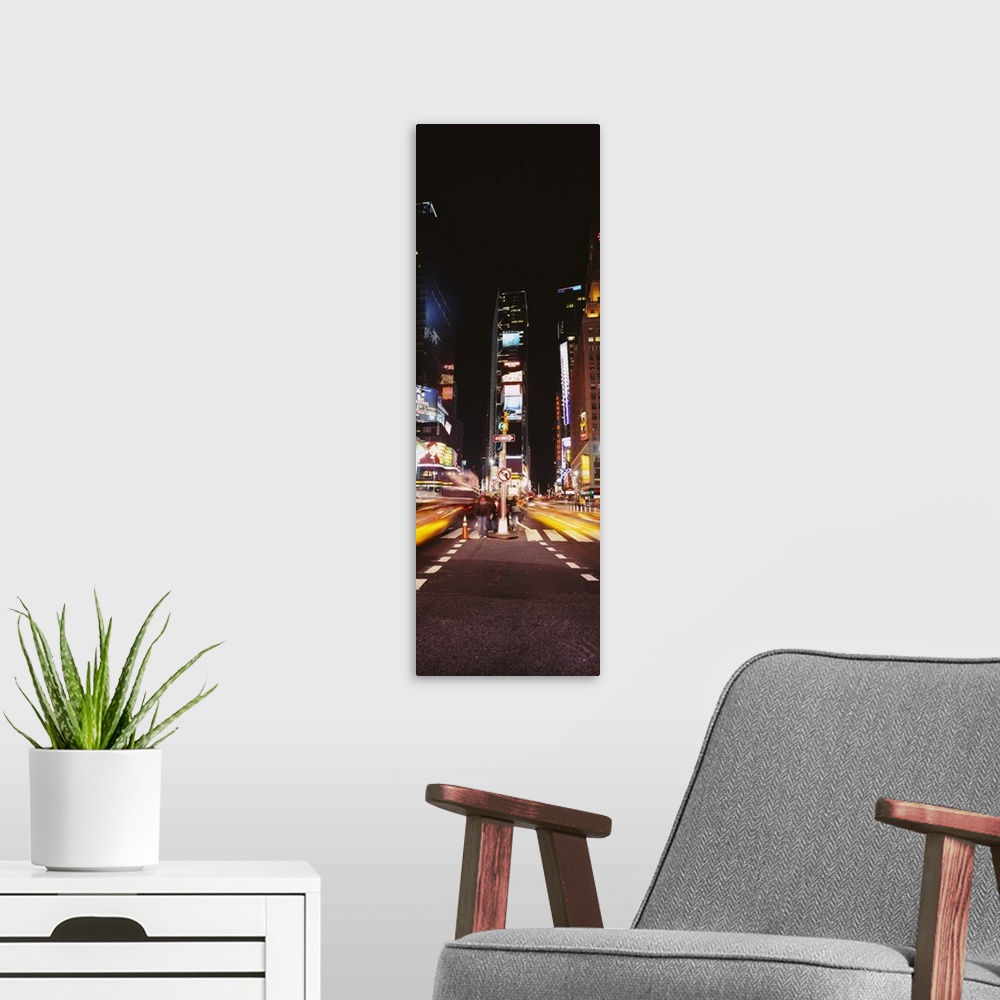 A modern room featuring This vertical time lapsed photograph shows the blur of motion created by cars driving through Tim...