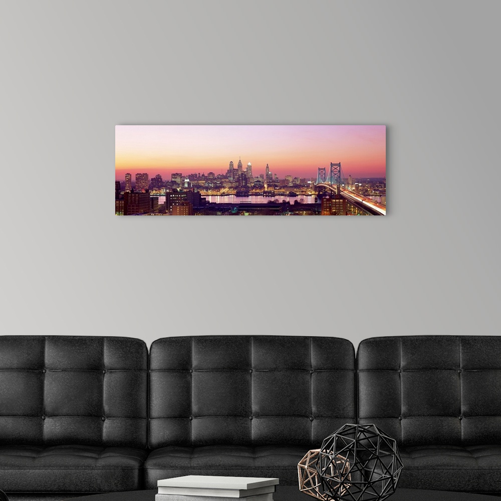 A modern room featuring Panoramic photograph displays the busy skyline and Benjamin Franklin bridge in Philadelphia, Penn...