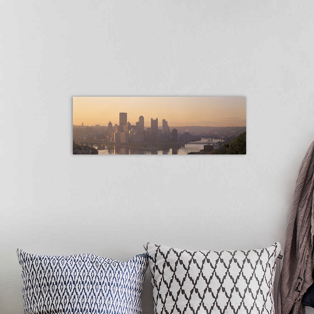A bohemian room featuring This is a panoramic photograph of the city skyline between two rivers becoming silhouetted in the...