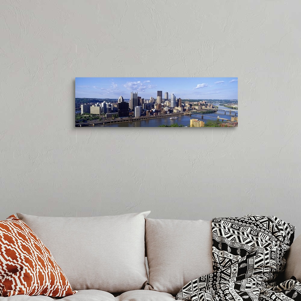 A bohemian room featuring Long photo on canvas of the cityscape of Pittsburgh with a river running through it.