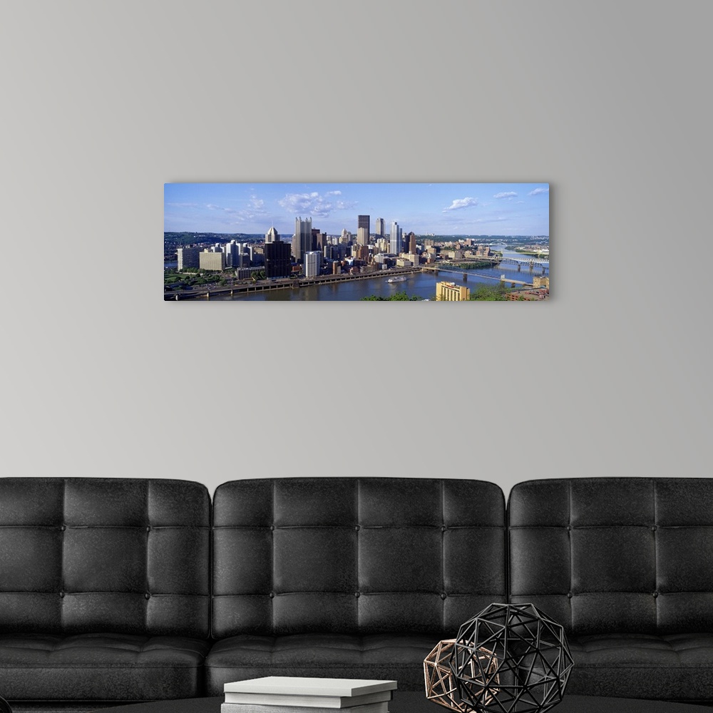 A modern room featuring Long photo on canvas of the cityscape of Pittsburgh with a river running through it.