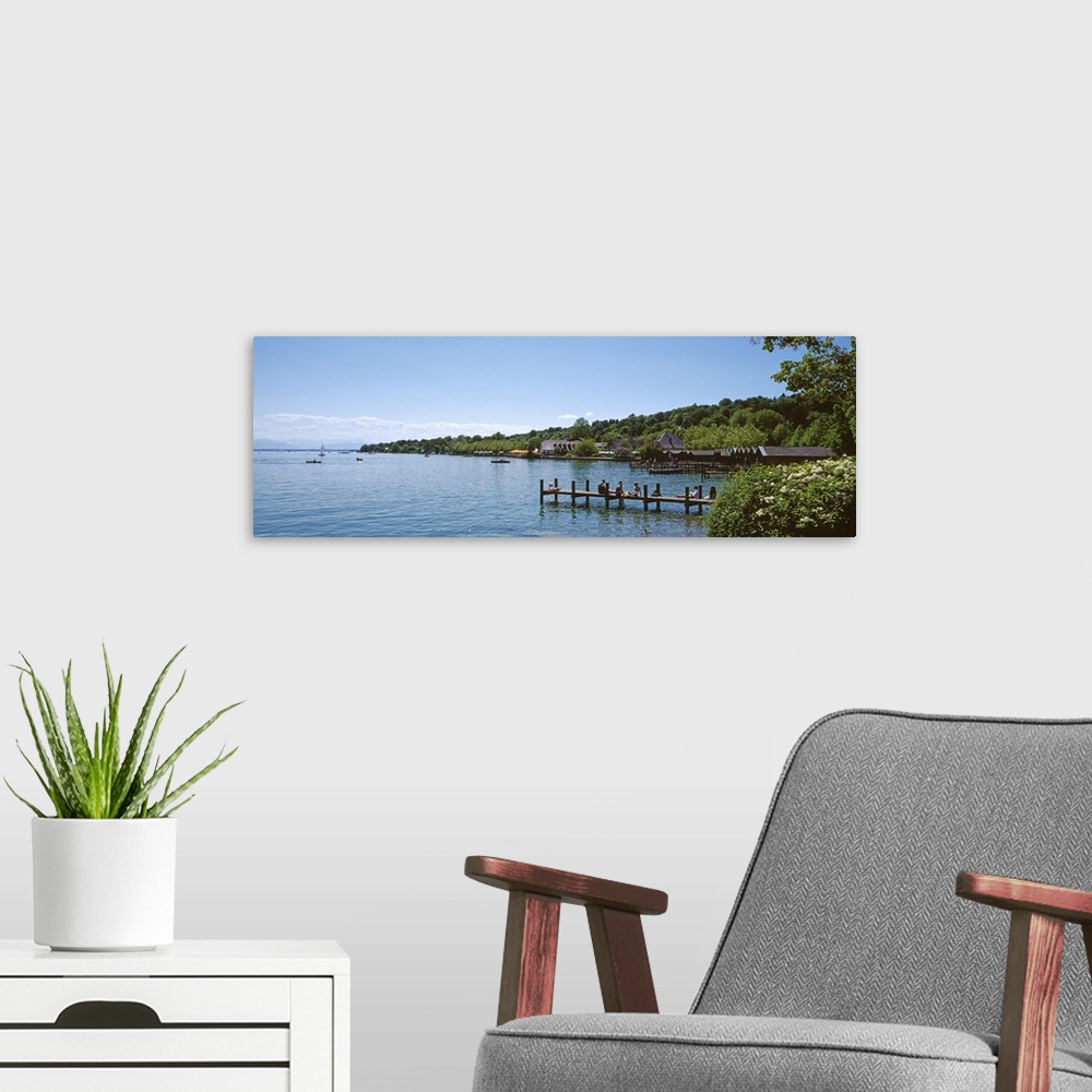 A modern room featuring People sitting on a jetty Lake Starnberg Starnberg Oberbayern Bavaria Germany