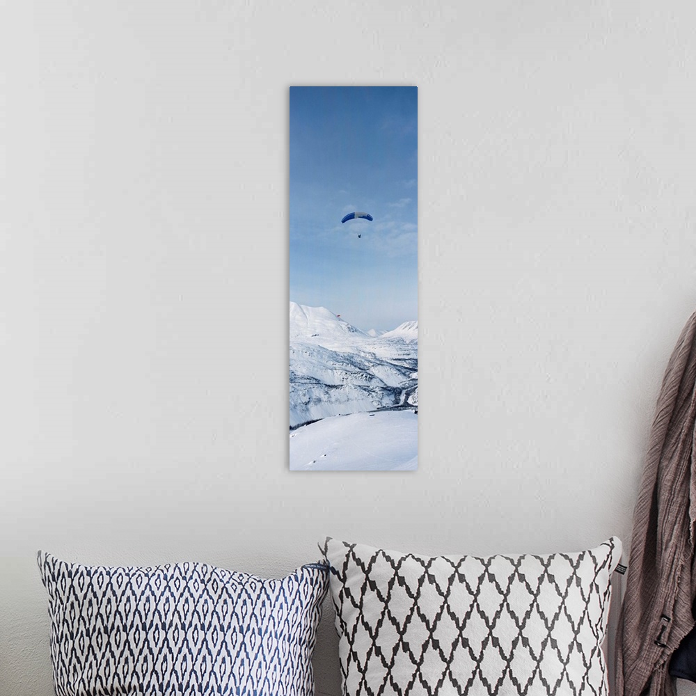 A bohemian room featuring Person parasailing over a snow covered mountain, Thompson Pass, Valdez, Alaska