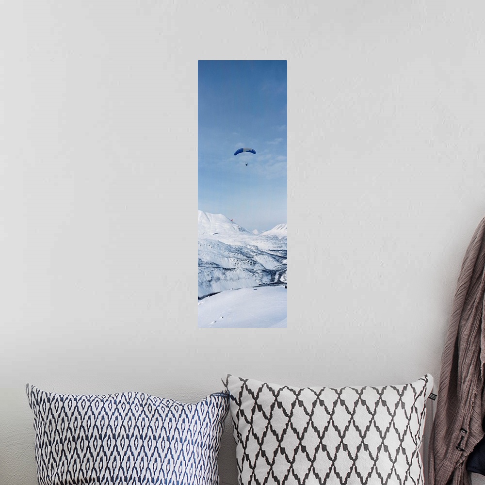 A bohemian room featuring Person parasailing over a snow covered mountain, Thompson Pass, Valdez, Alaska