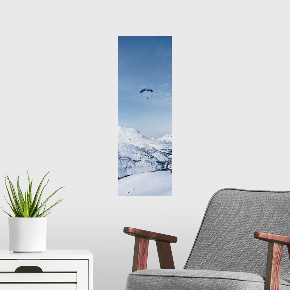 A modern room featuring Person parasailing over a snow covered mountain, Thompson Pass, Valdez, Alaska