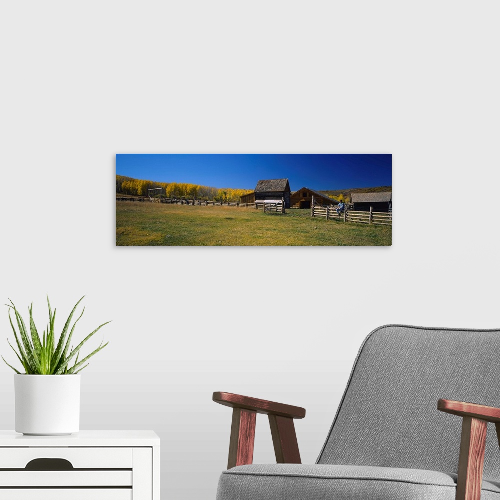 A modern room featuring Person sitting on a fence, Last Dollar Ranch, Colorado