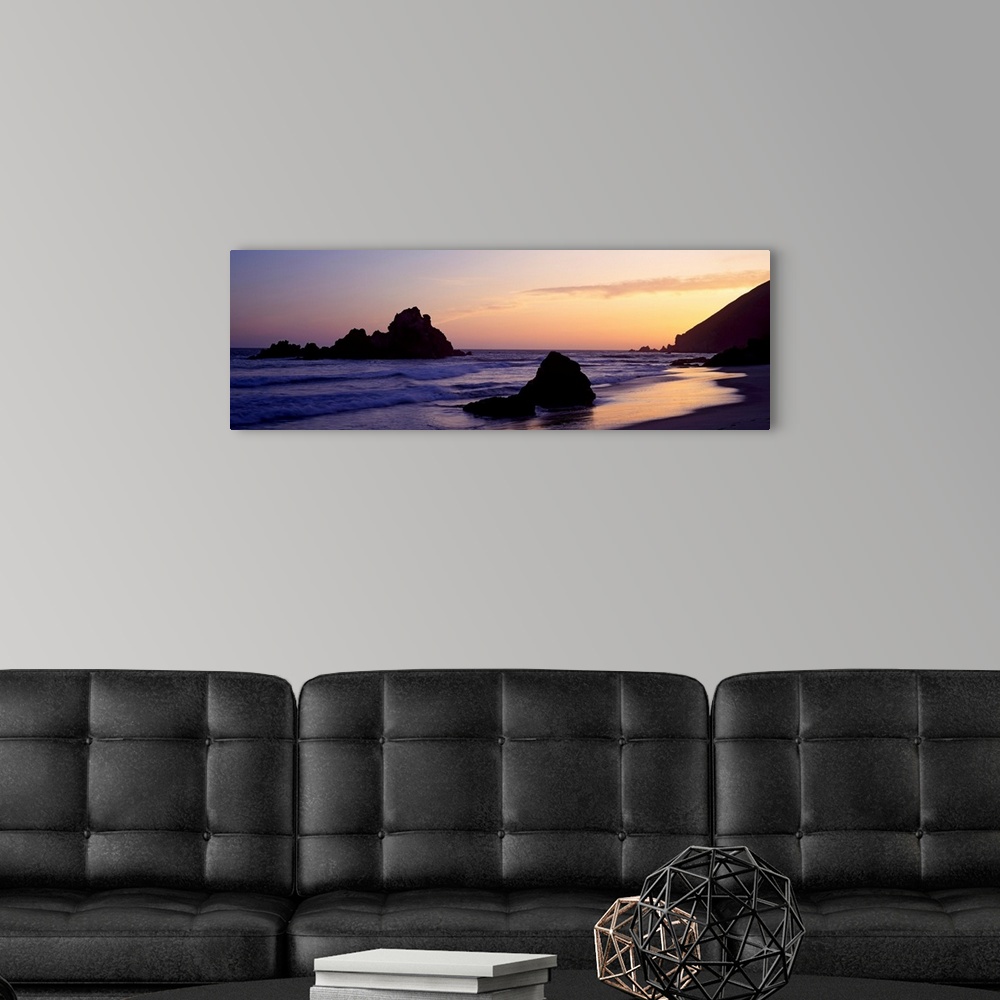 A modern room featuring Oversized, horizontal, panoramic photograph of the shoreline at Pfeiffer Beach in Big Sur, Califo...