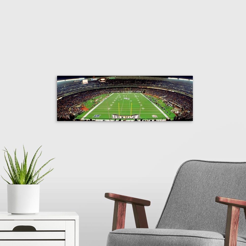 A modern room featuring Panoramic photograph taken above an end zone of a National Football League team's field located w...