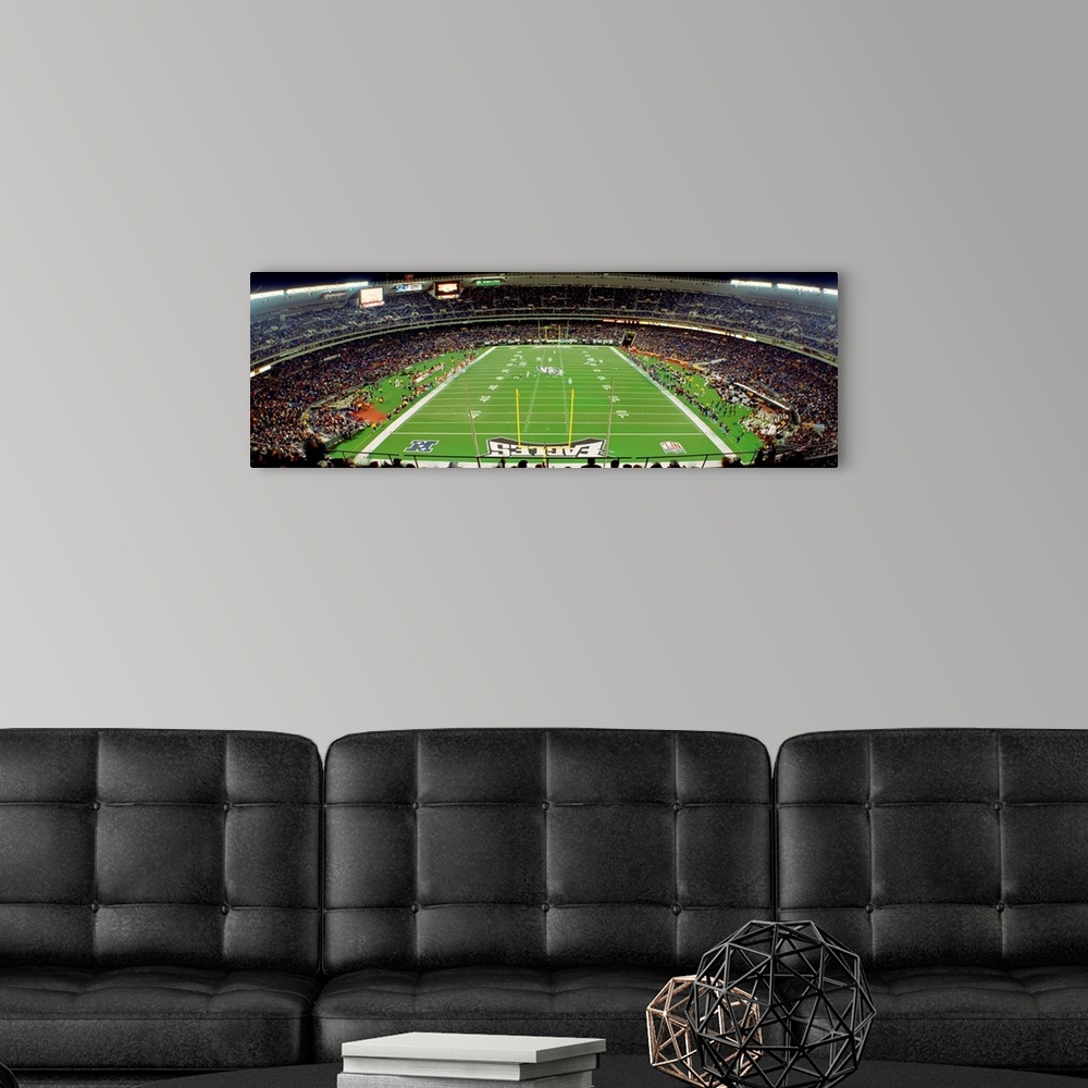 A modern room featuring Panoramic photograph taken above an end zone of a National Football League team's field located w...