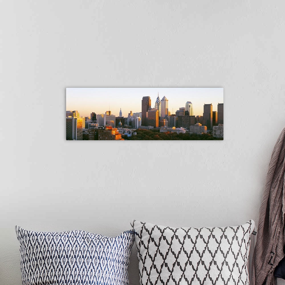 A bohemian room featuring Giant, panoramic photograph of the sun shining on the skyline of Philadelphia.