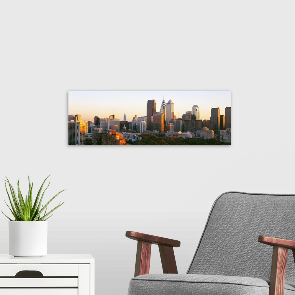 A modern room featuring Giant, panoramic photograph of the sun shining on the skyline of Philadelphia.