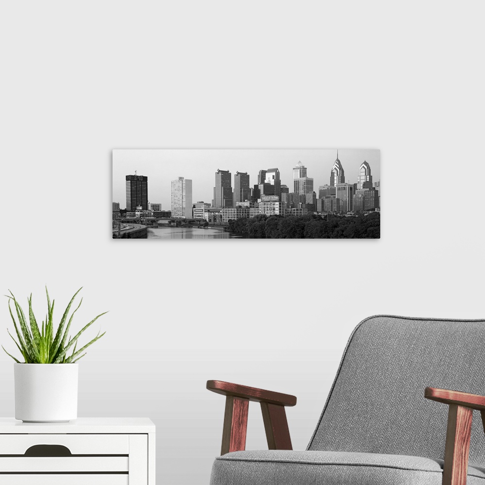 A modern room featuring Panoramic photograph taken in black and white of the skyline in Philadelphia. A highway is seen t...