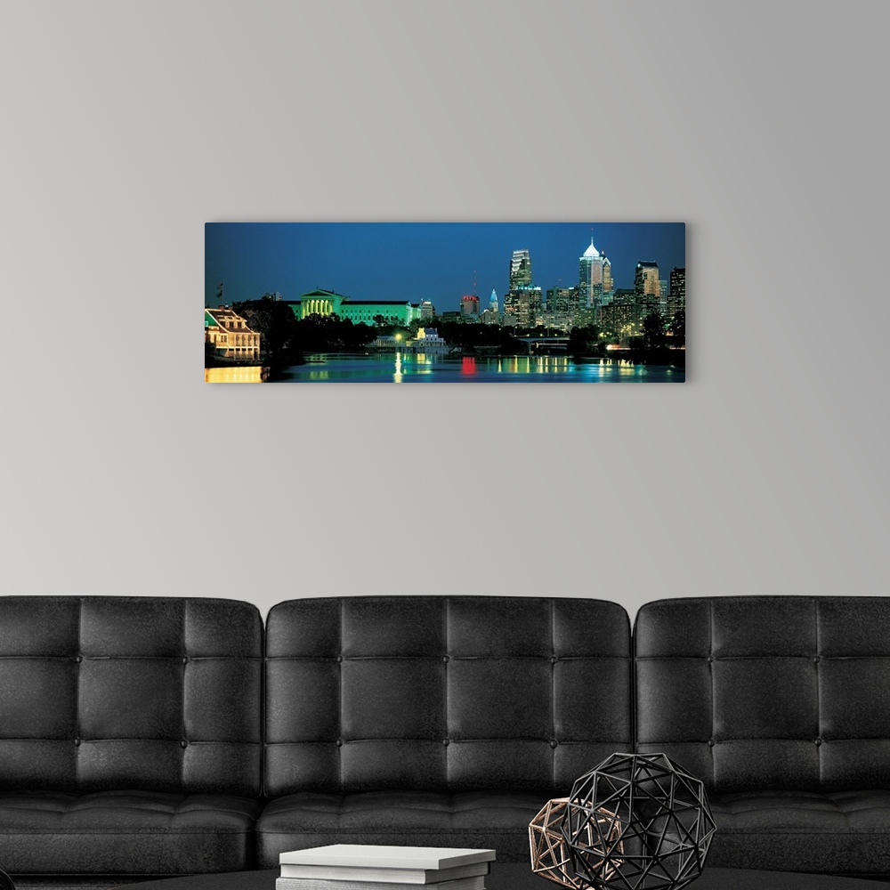 A modern room featuring Panoramic photograph of the Philadelphia, Pennsylvania skyline taken at night.  The bright lights...
