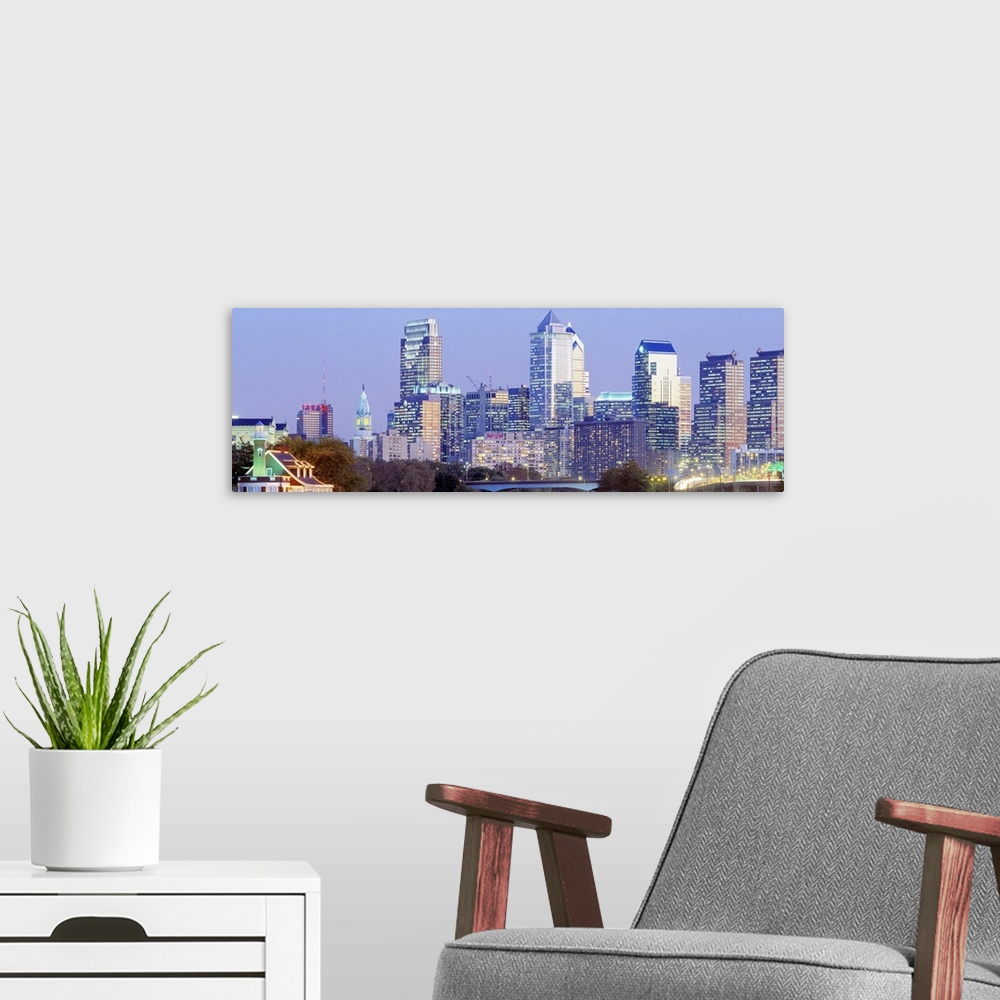 A modern room featuring Downtown  skyline taken at night with boathouse row lights lit up.