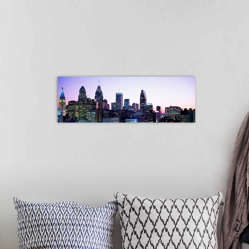 A bohemian room featuring A panoramic photograph of the downtown city skylineos skyscrapers at dusk.