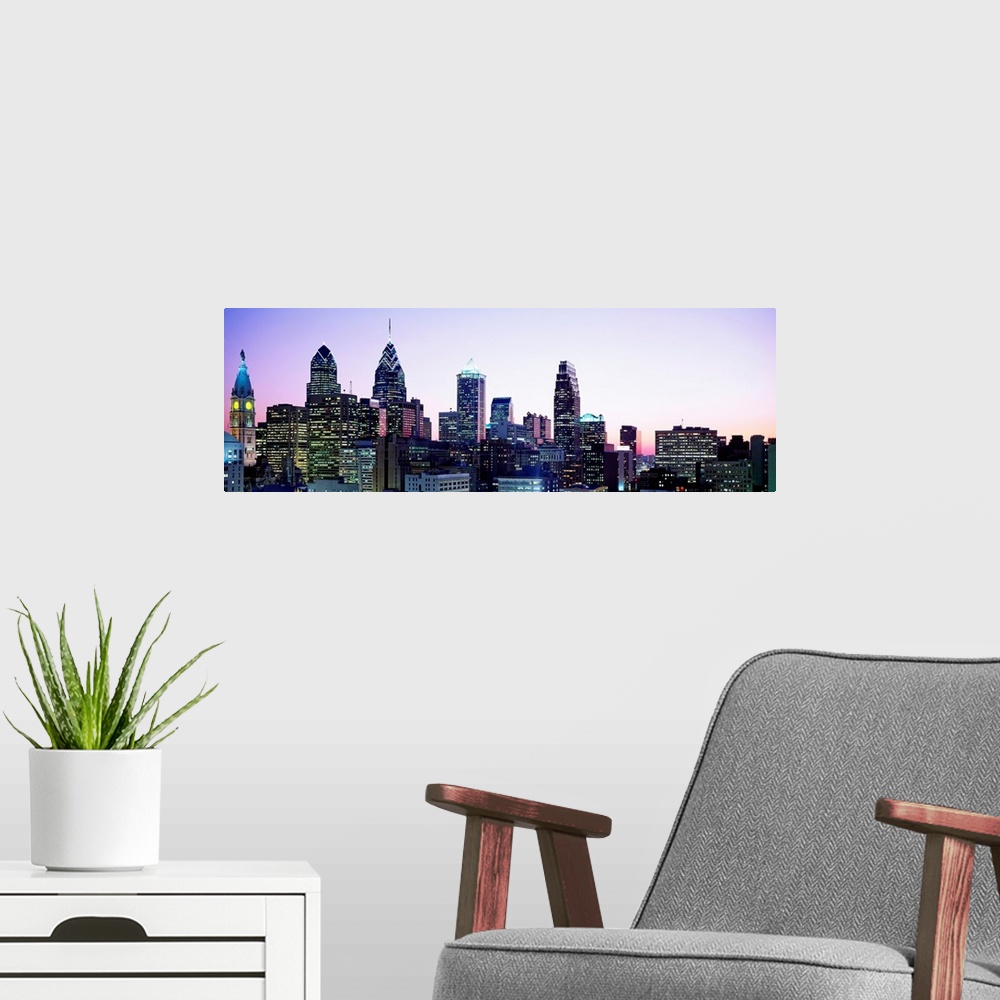 A modern room featuring A panoramic photograph of the downtown city skylineos skyscrapers at dusk.