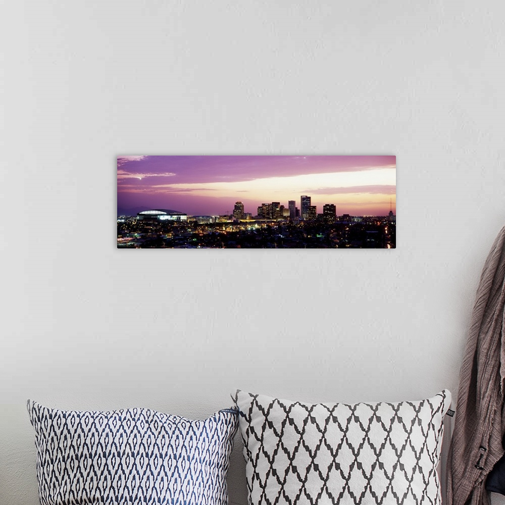 A bohemian room featuring Panoramic photograph of city skyline lit up at sunset.