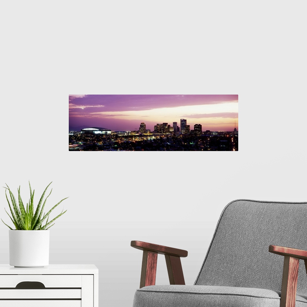 A modern room featuring Panoramic photograph of city skyline lit up at sunset.