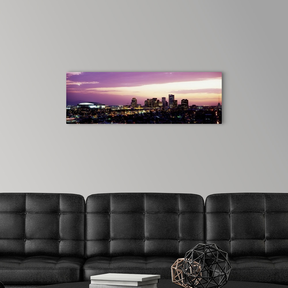 A modern room featuring Panoramic photograph of city skyline lit up at sunset.