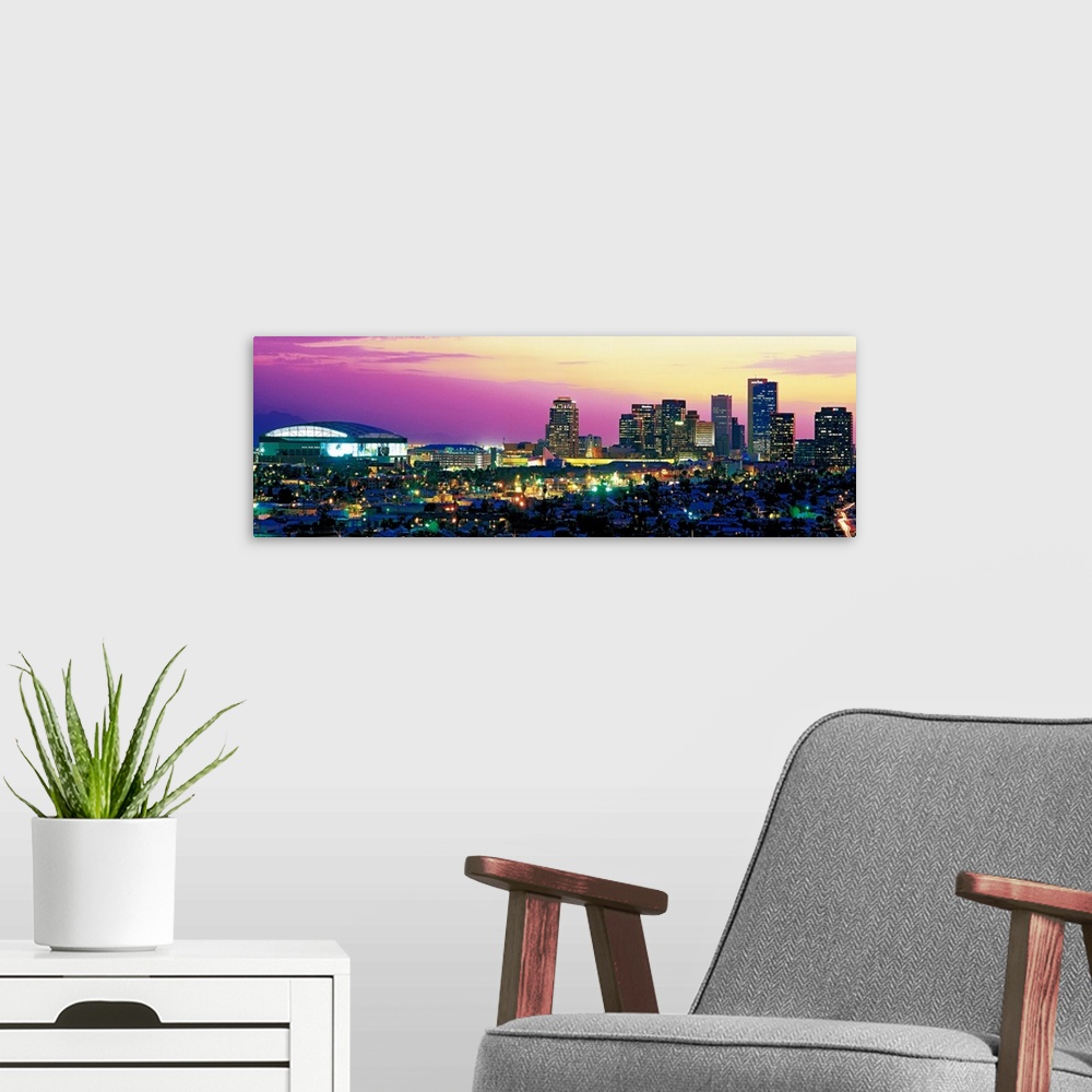 A modern room featuring Panoramic photograph displays the colorful skyline within the capital of Arizona as it brightly s...