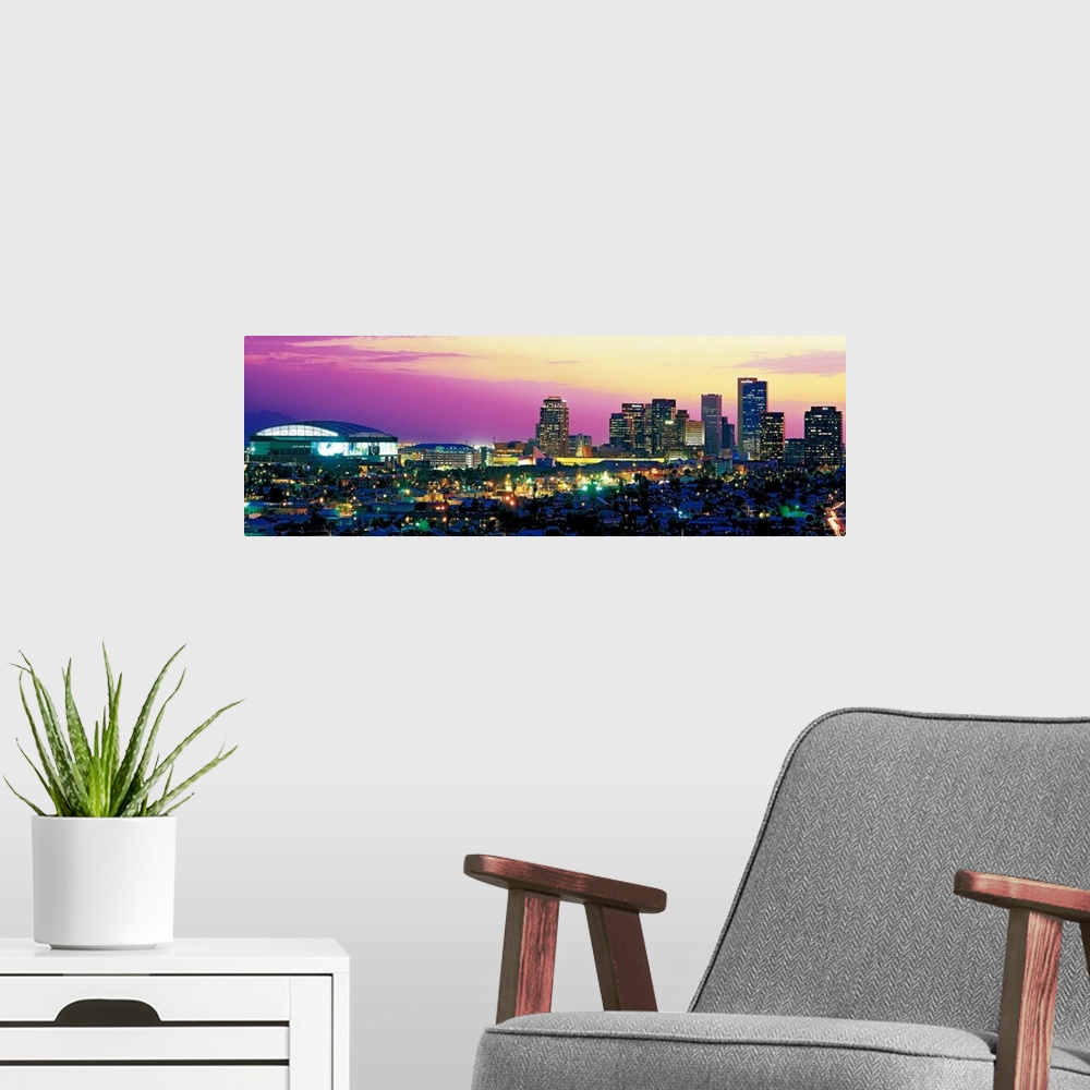 A modern room featuring Panoramic photograph displays the colorful skyline within the capital of Arizona as it brightly s...