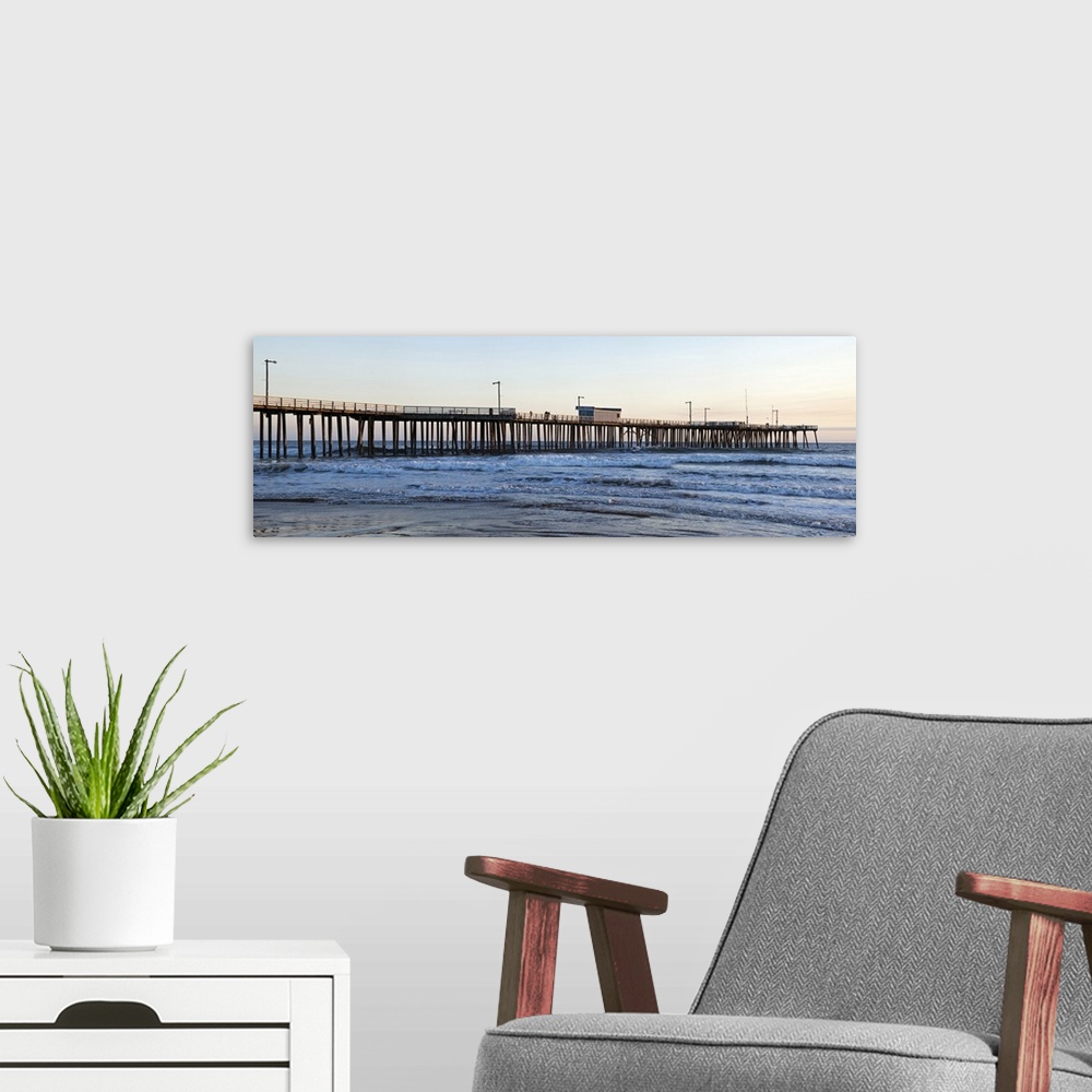 A modern room featuring Large landscape photograph of Pismo Beach Pier extending into the waters along Pismo Beach, in Sa...