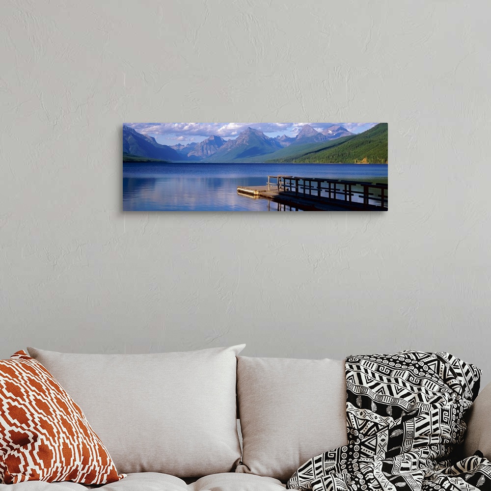 A bohemian room featuring Dock on the water with mountains in the background at Lake McDonald Glacier National Park in Mont...
