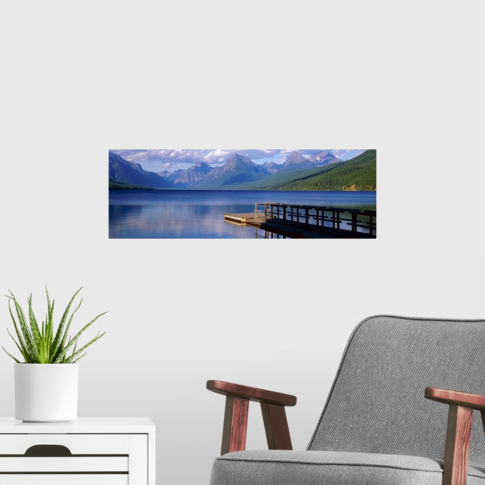 A modern room featuring Dock on the water with mountains in the background at Lake McDonald Glacier National Park in Mont...