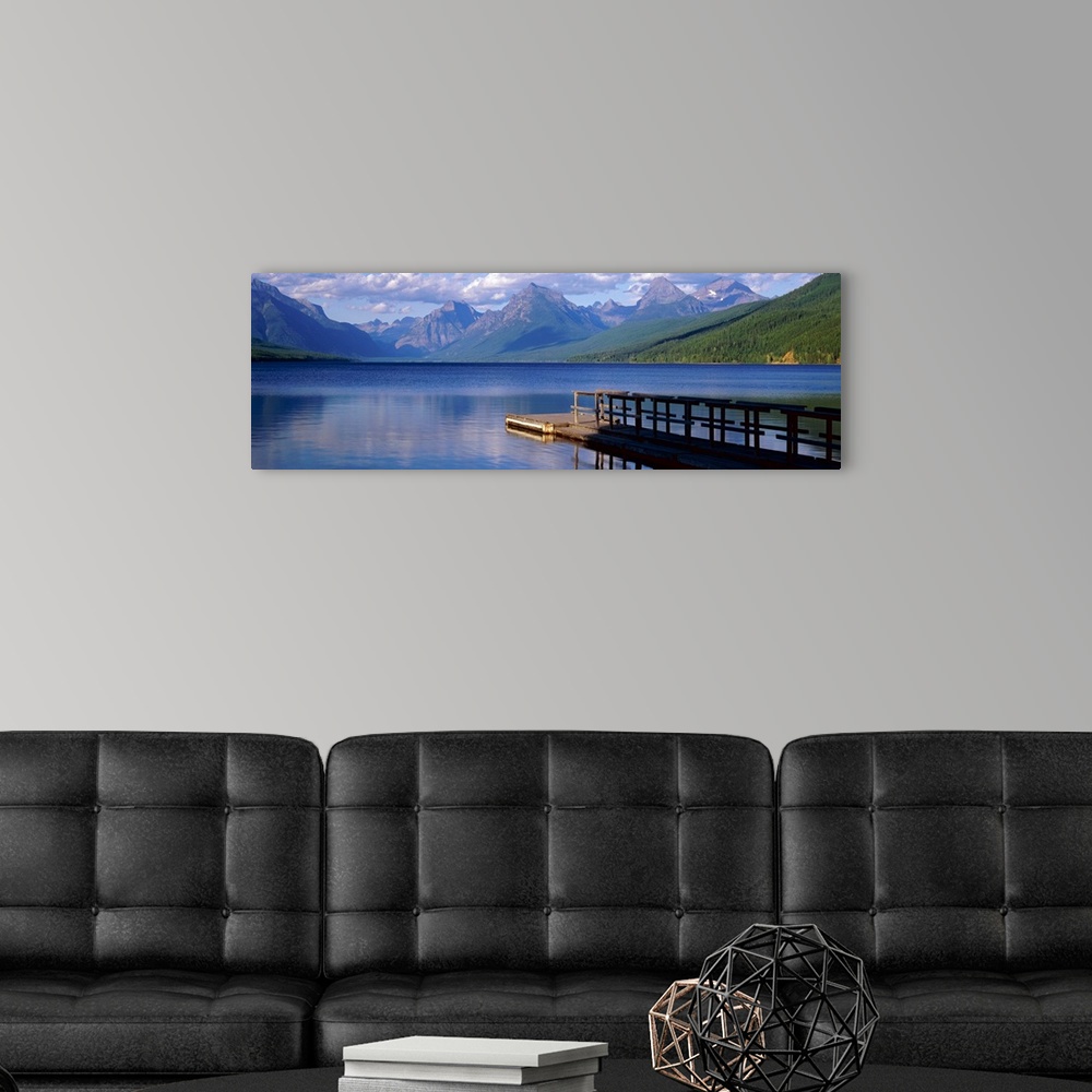 A modern room featuring Dock on the water with mountains in the background at Lake McDonald Glacier National Park in Mont...