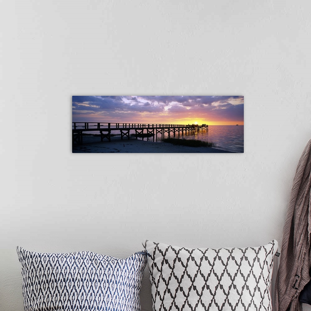 A bohemian room featuring Oversized, panoramic photograph of the pier extending into the water, toward the setting sun at C...