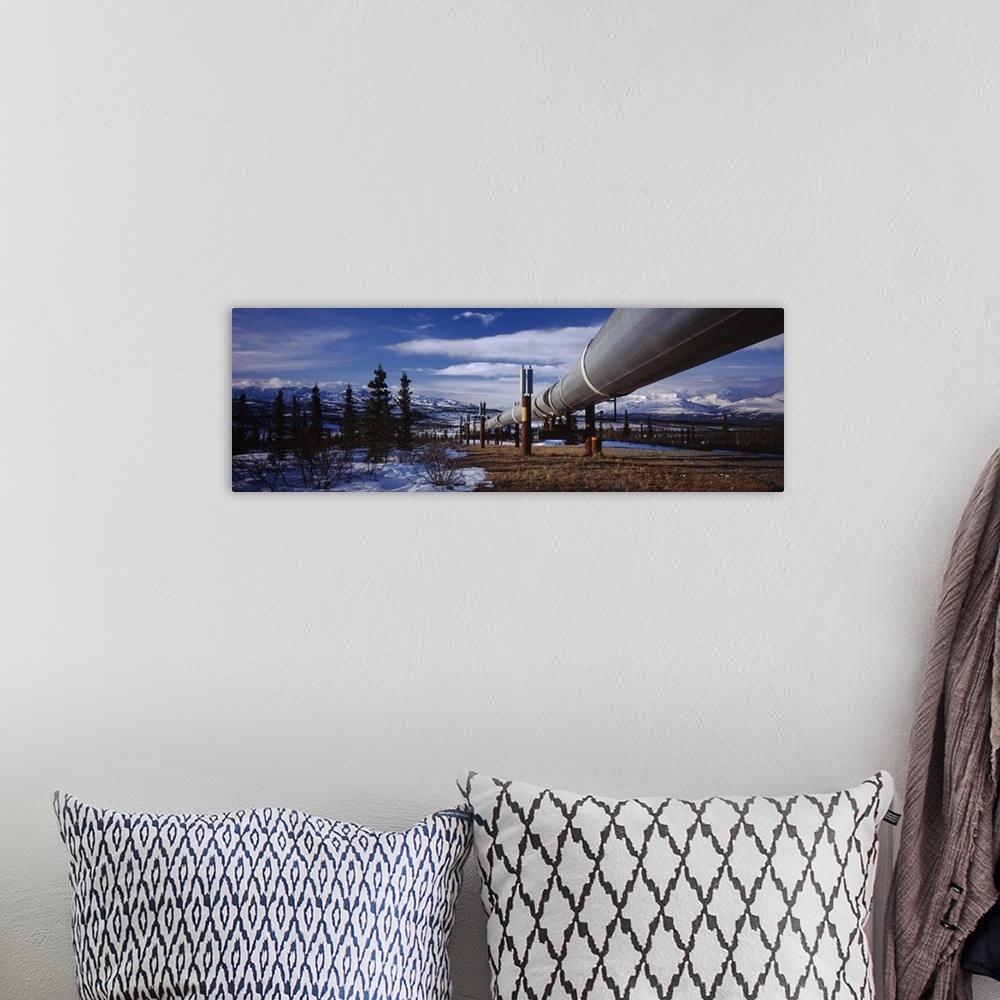 A bohemian room featuring Pipeline passing through a snow covered landscape, Trans-Alaskan Pipeline, Alaska