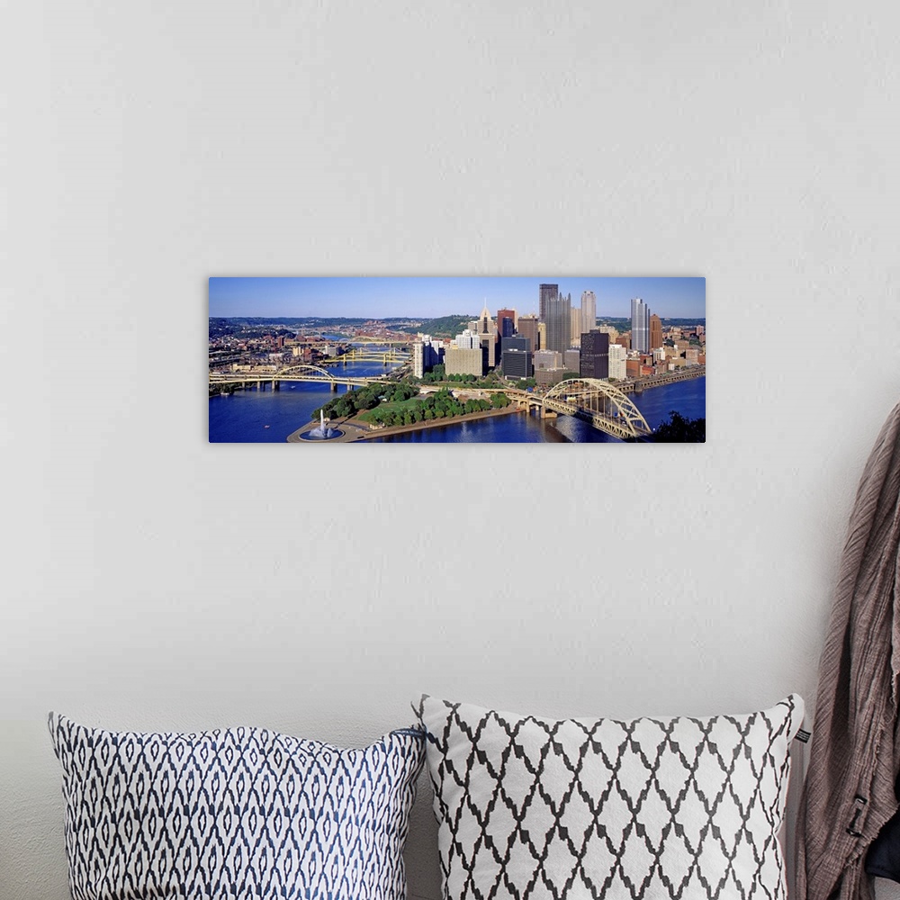 A bohemian room featuring Panoramic photograph of the skyline, bridges, and Point State Park where the three rivers meet.