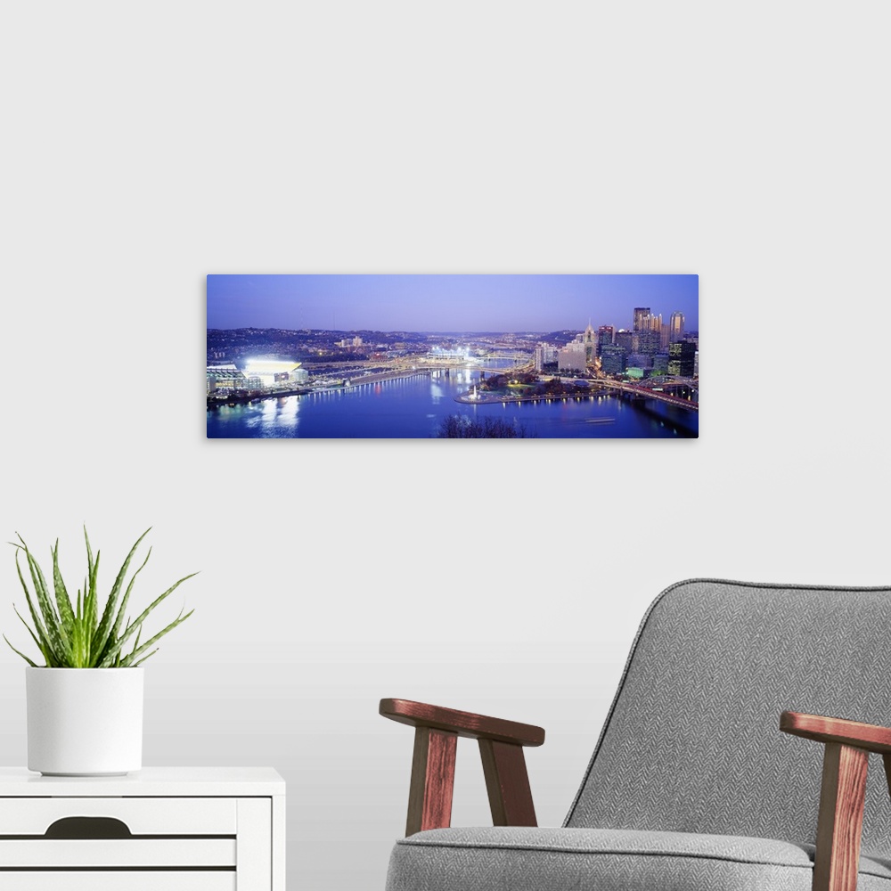 A modern room featuring Panoramic photograph displays an aerial view overlooking the busy skyline of a city within the No...