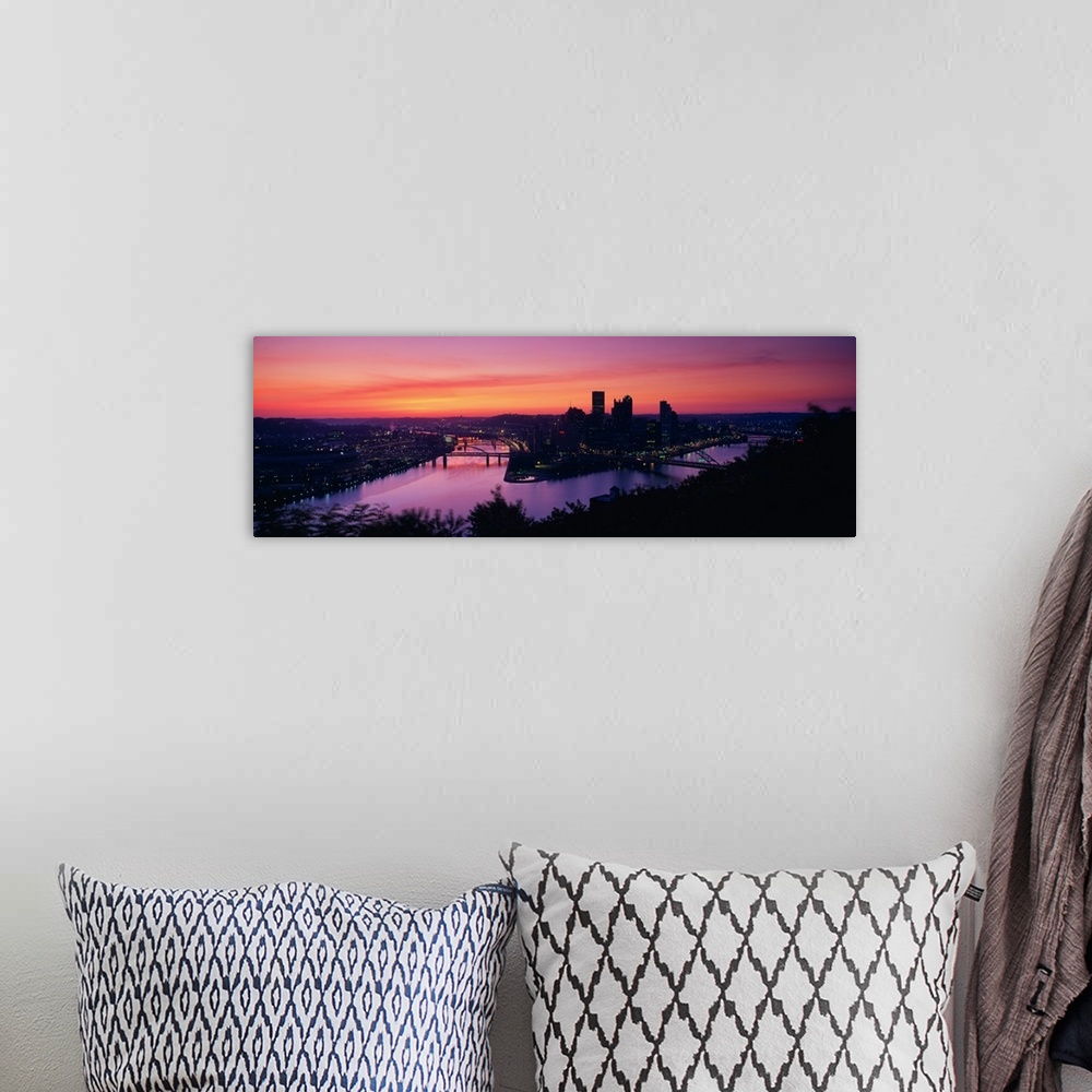 A bohemian room featuring Oversized, landscape photograph of the distant skyline of Pittsburgh, Pennsylvania lit up, beneat...