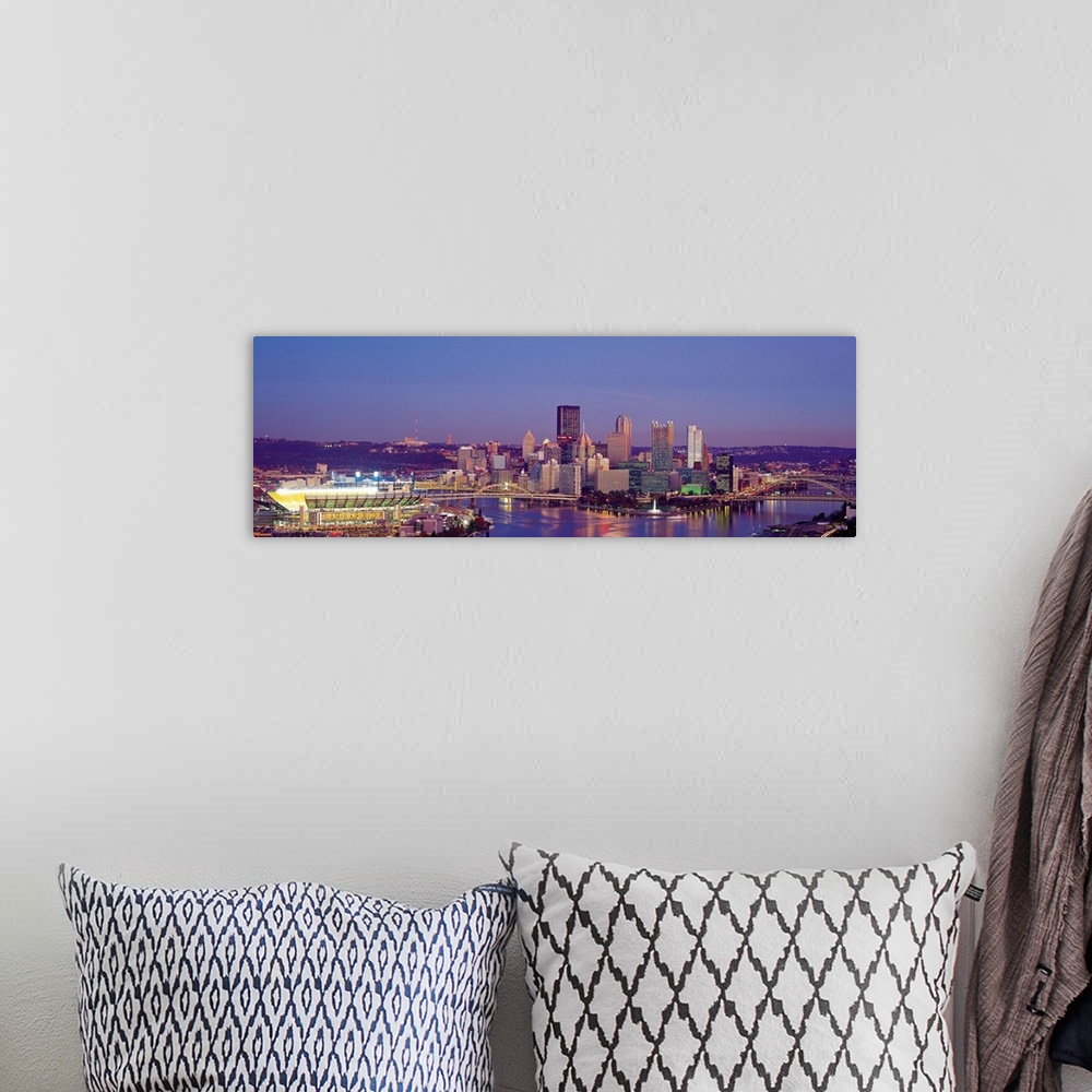 A bohemian room featuring Large panoramic photograph of Three Rivers and the  Pittsburgh skyline at dusk.