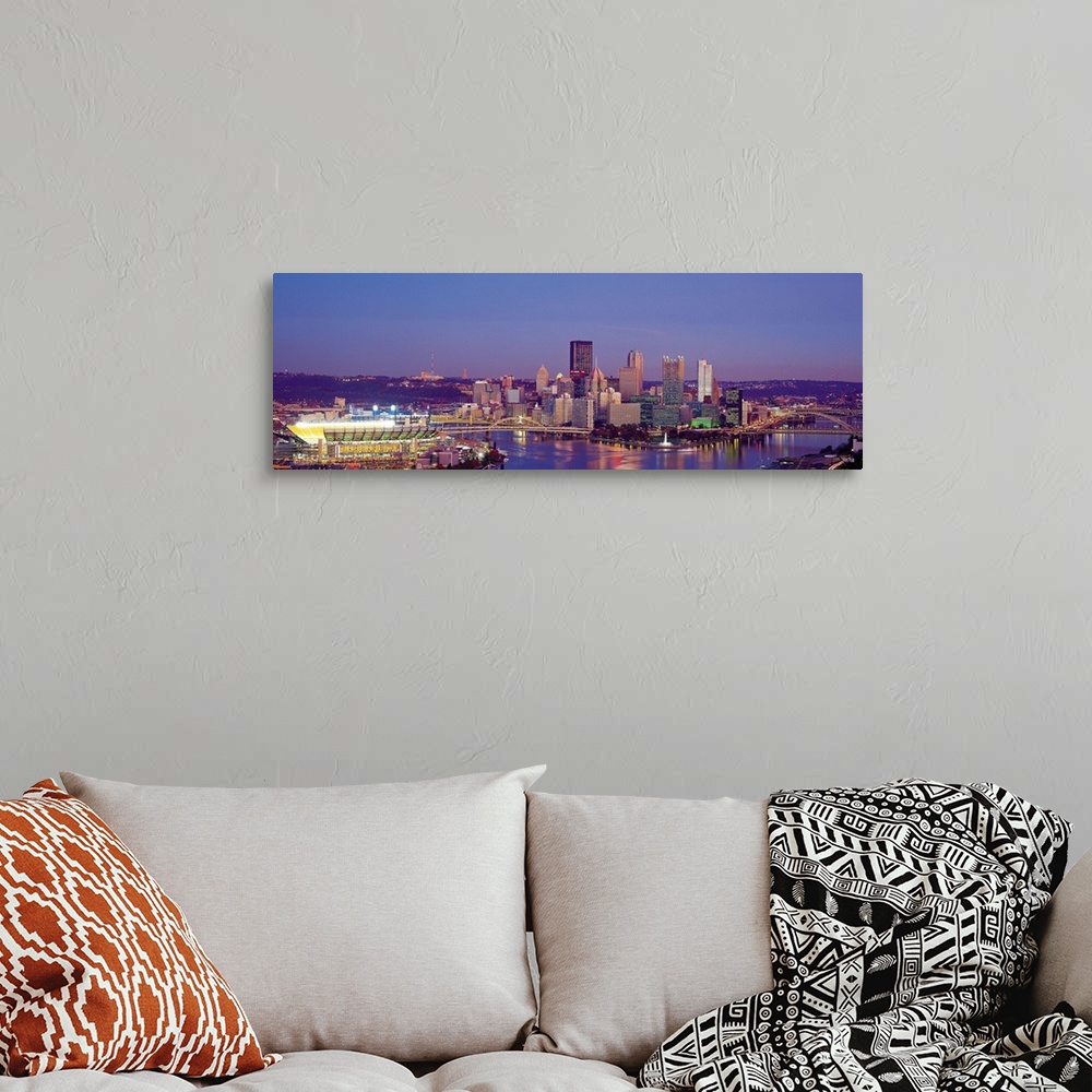 A bohemian room featuring Large panoramic photograph of Three Rivers and the  Pittsburgh skyline at dusk.