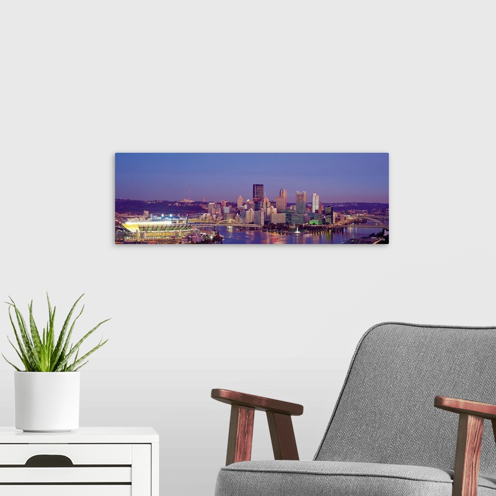 A modern room featuring Large panoramic photograph of Three Rivers and the  Pittsburgh skyline at dusk.