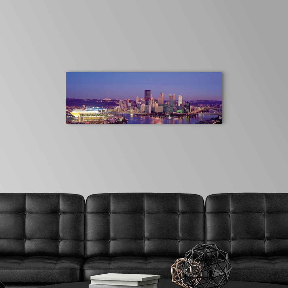 A modern room featuring Large panoramic photograph of Three Rivers and the  Pittsburgh skyline at dusk.