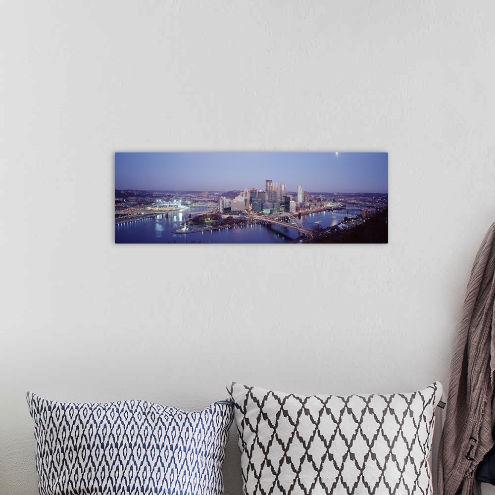A bohemian room featuring Panoramic photograph of city skyline at dusk.  Iconic buildings, bridges, and waterways are featu...