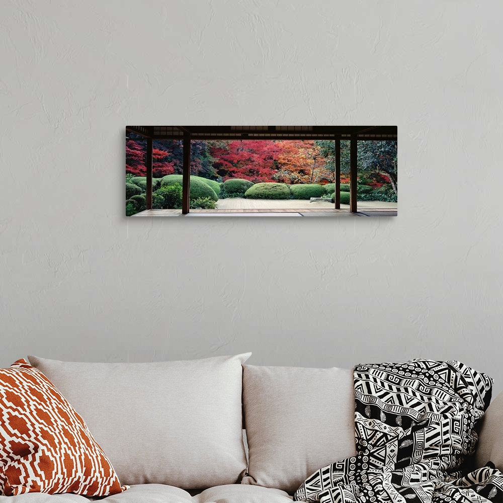A bohemian room featuring This panoramic photograph is taken from inside a temple and looking out into a forest filled with...