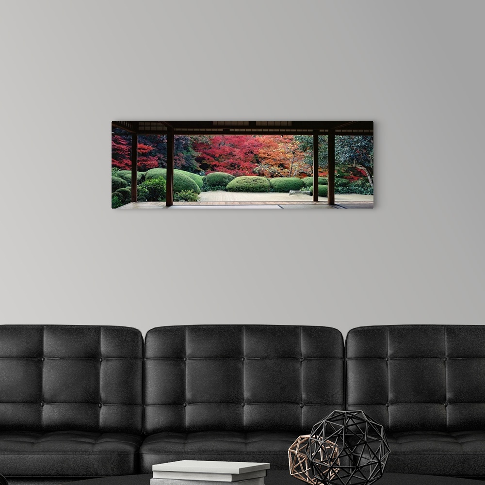 A modern room featuring This panoramic photograph is taken from inside a temple and looking out into a forest filled with...