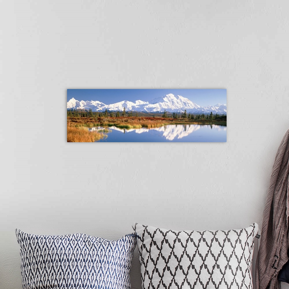 A bohemian room featuring Panoramic photograph shows a range of snow covered mountains filling the horizon and sitting behi...