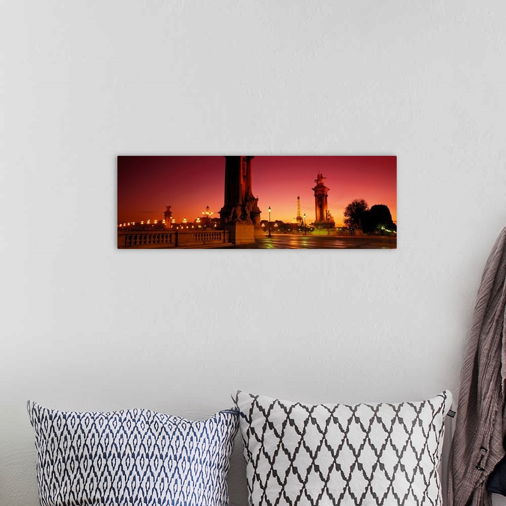A bohemian room featuring Panoramic photograph of street view with street lamps lit up at night.